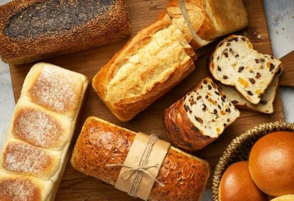 COBS Bread viewed from above. An assortment of sourdough, fruit bread, and seed loaves.